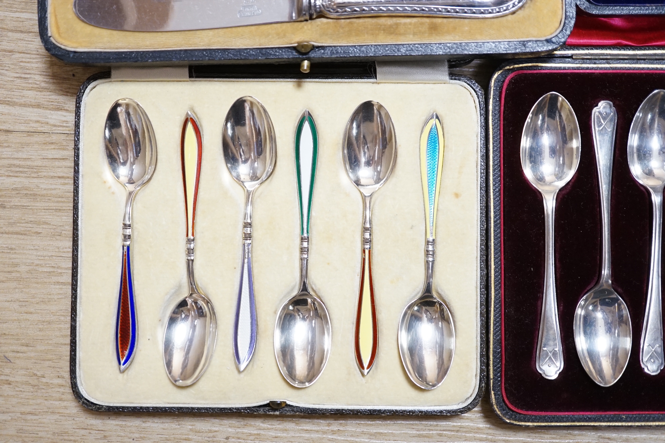 A cased set of six George V silver and polychrome enamel coffee spoons, Barker Brothers Silver Ltd, Birmingham, 1932, four other cased sets including teaspoons and tea knives and seventeen assorted Towle sterling handled